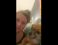 Dog showing teeth when kissed by hooman 