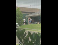 Family neighbor dances outside the garage