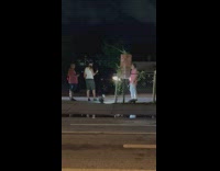 Man pink shirt dance parking lot commentary