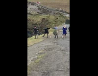 Tourists pose on mountain edge 