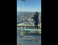 Woman in black jacket coat stands on the bench at the Observation deck