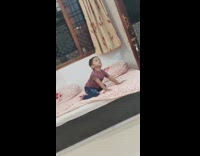 Kid on bed pretending he is wolf and howling