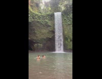 Two girls stand dance waterfall water rock