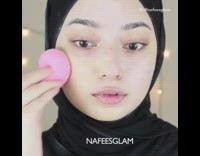 Woman With Hijab Does Makeup With Pink Eye Shadow