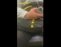 Man asleep while travel inside train holds phone 