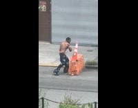 Collab WINY - Shirtless man punch traffic cone street barricade