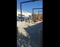 Man plays bongo sit near restaurant with photographer