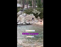 Woman strike pose lay on rock beach