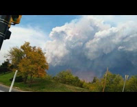 Large smoke cloud from fire car grass