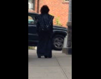 Woman wears disney villain costume on street
