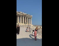 Two girls sit pose grey skirt Parthenon