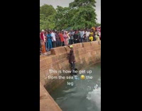 Man Climbs Up Wall Ledge with Foot 