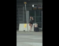 Black shirt girl selfies outside empty airport