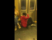 Guy smokes sitting on train 