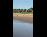 Woman Runs Back and Forth at Beach for Video 