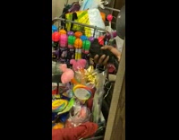 Guy has cart of toys and eggs on train 