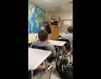 Guy in black shirt in classroom does karate kicks and spins 