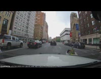 Person in Green Sits Cross Legged on Road 