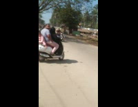 Baby girl sits on back of scooter 