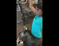 Girl uses lat pulldown machine at the gym, puts phone under weight and cracks screen