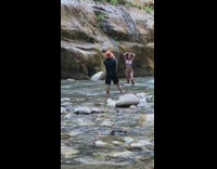 Bikini girl creek water orange hat guy