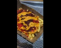 Girl eats burger with cheese and cheetos