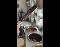 Woman buys chocolate dipped banana for dessert