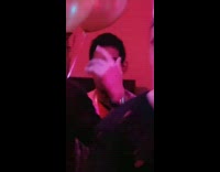 Guy at party with straight face 