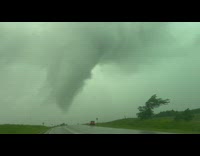 Closeup of a large tornado in the sky near the road