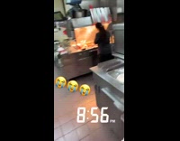 Little boy working in fast food restaurant kitchen 
