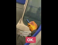 Man uses phone on train with hand covered in glitter sparkles