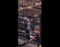 Girl stands in middle of concert seats