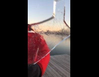 Man throws thick ice on frozen lake