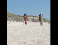 White bikini top red pants girl sand 