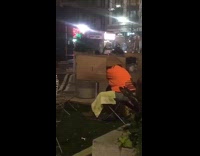 Guy orange shirt cardboard box fake grass