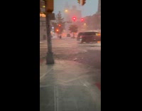 Car drive through flooded street rain storm