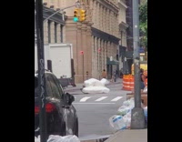 White truck drives drags mattress traffic cone