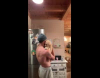 Shirtless man beanie hat carry golden retriever puppy