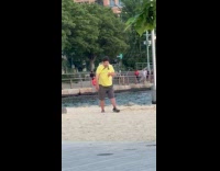 Man at park with pigeon on leash