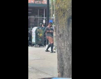 Woman gray shirt no pants dance street