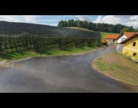 Rain falls on the farm field with clear sky