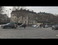 Woman in beige trench jacket between traffic