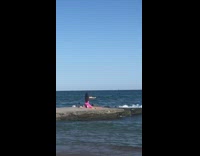 Pink leggings girl flat rock ocean water