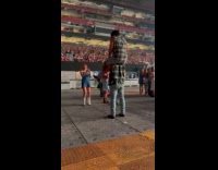 Collab IITW - Man lifts another man for photo at concert