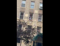 Woman blue top out on window sill