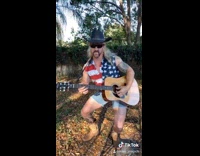 Guy black cowboy hat tiger dog guitar 