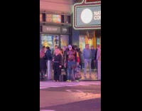 Shirtless man with scary clown mask on street 