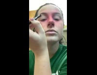 girl putting on red face makeup dogs staring at her