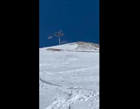 Skier jumps off ramp red jacket