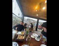 Two men takes picture of a man with their food